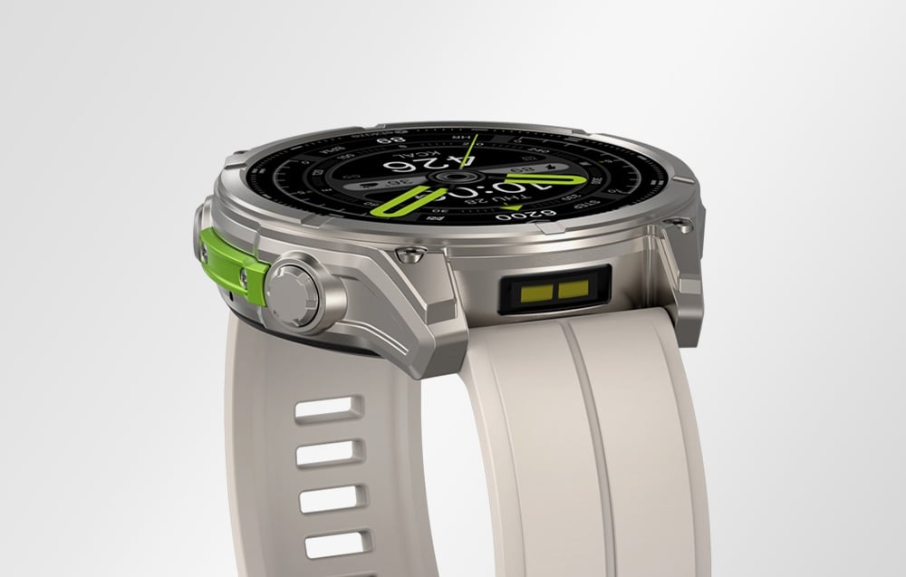 Smartwatch with metal envelope and bright strap with green accents, side view on bright background