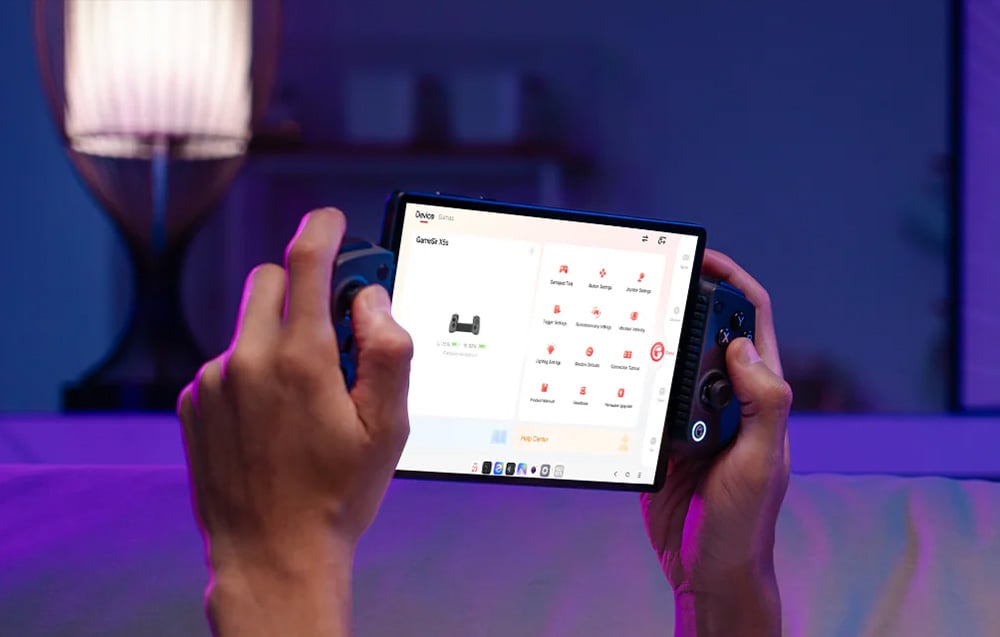 Person holding portable console with controllers and screen displaying settings menu in room with purple lighting