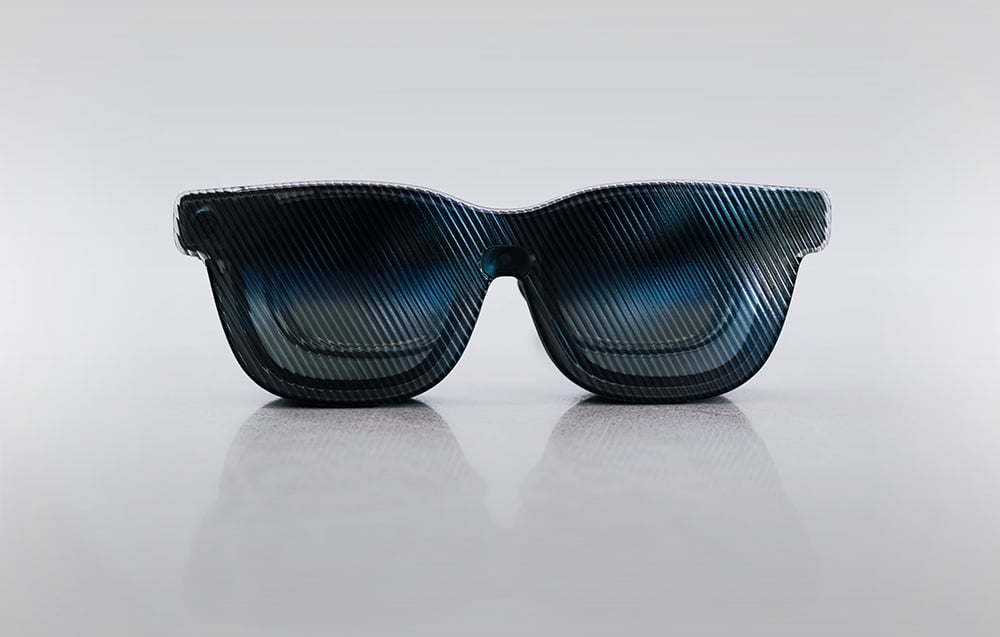 Black Viture glasses with sun visor on a gray background