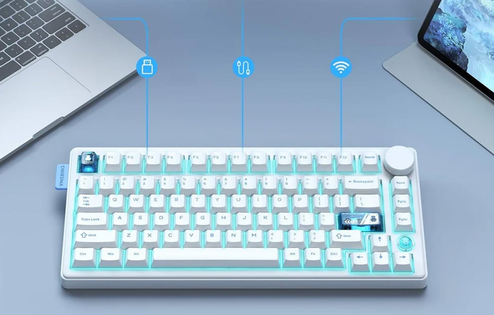 White and blue keyboard on table next to laptop and tablet