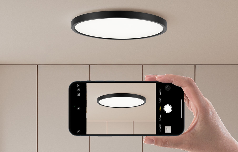 Yeelight Meteor C400 ceiling lamp on a beige ceiling, photographed with a smartphone.