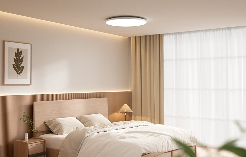 Bright bedroom with bed and eelight Mercury C300 smart ceiling light on.