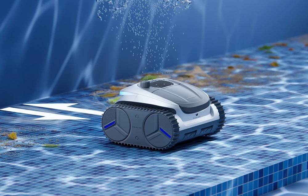 The cleaning robot moves along the pool floor, collecting leaves and debris