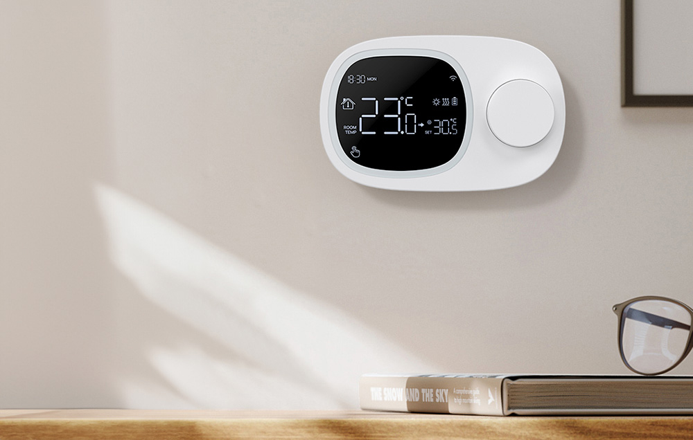 Smart thermostat on bright wall above wooden shelf