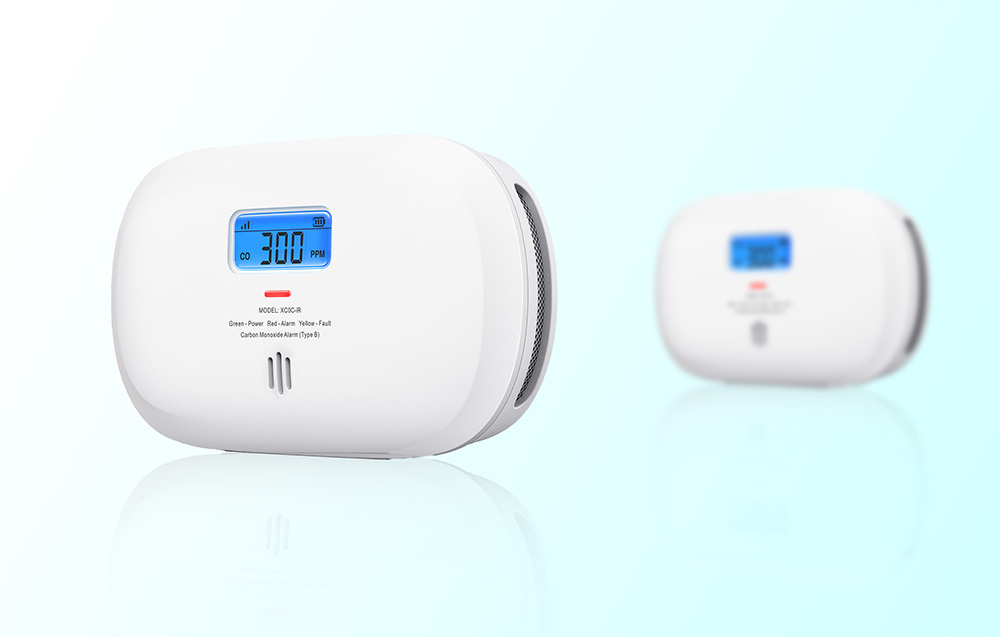 Two carbon monoxide detectors, one in the foreground, the other blurred in the background