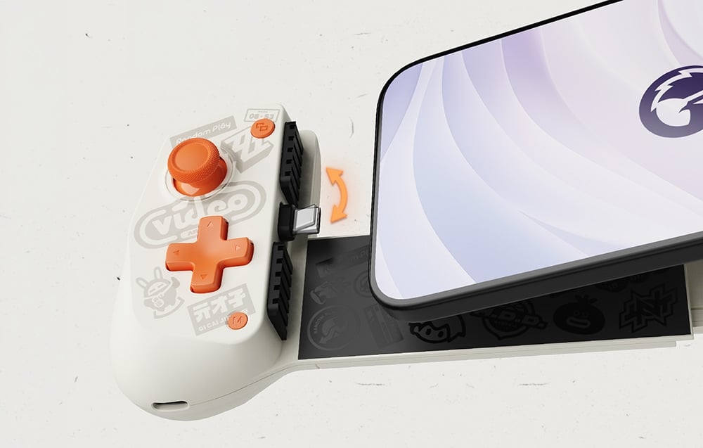 Close-up of a slide-out smartphone controller with a white casing, orange buttons, and a visible USB-C port