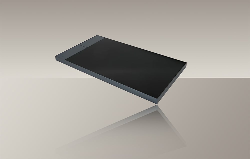 Dark gray touch panel with screen off with reflection on light surface
