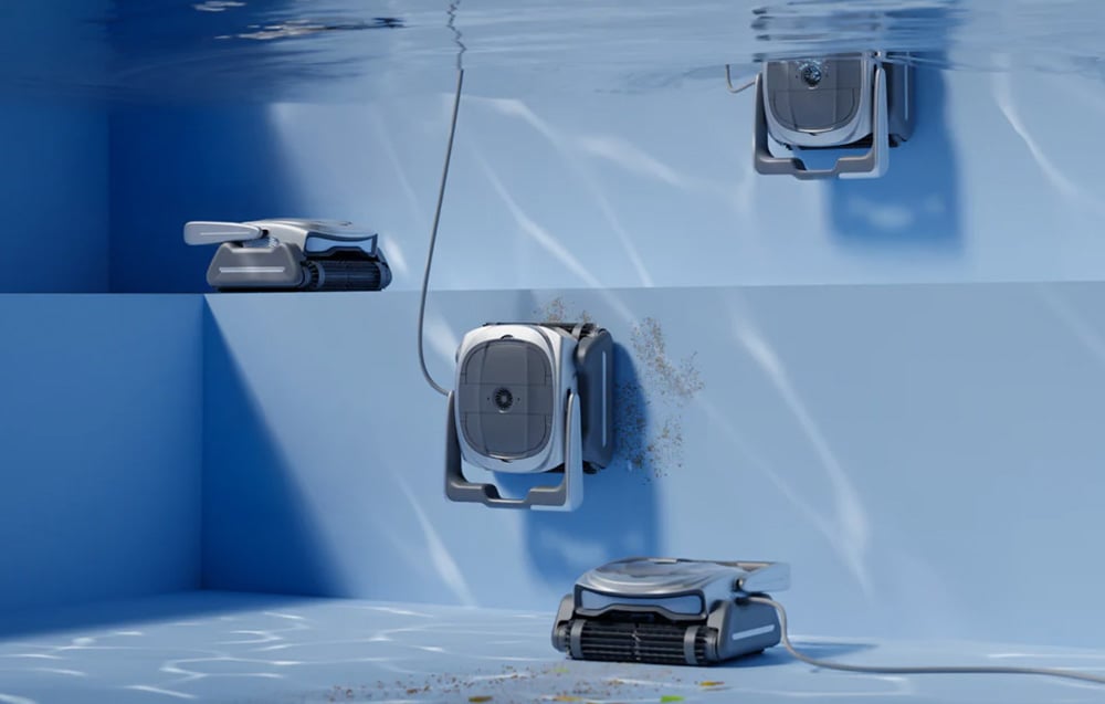 Four pool robots climb the pool walls, cleaning them of sediment and dirt