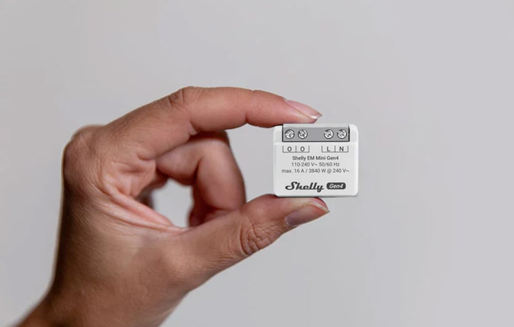Shelly white energy meter held in hand