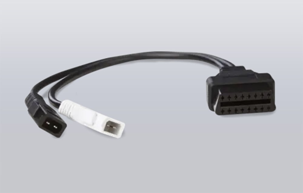 Black VAG 2x2 to OBD-II adapter on a gray background