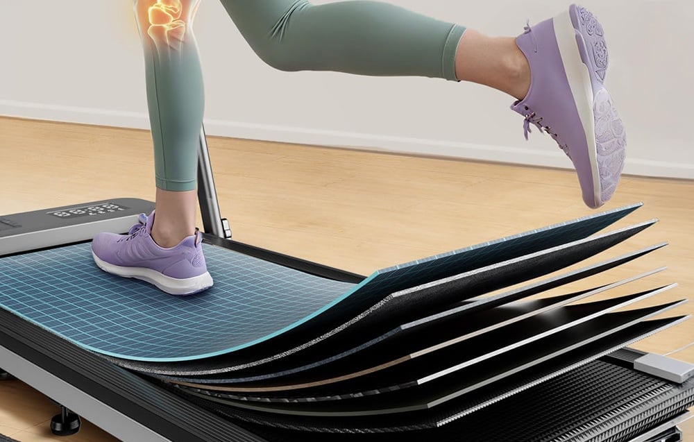 Close-up of the multi-layered running belt of a treadmill with a person running in leggings and purple shoes
