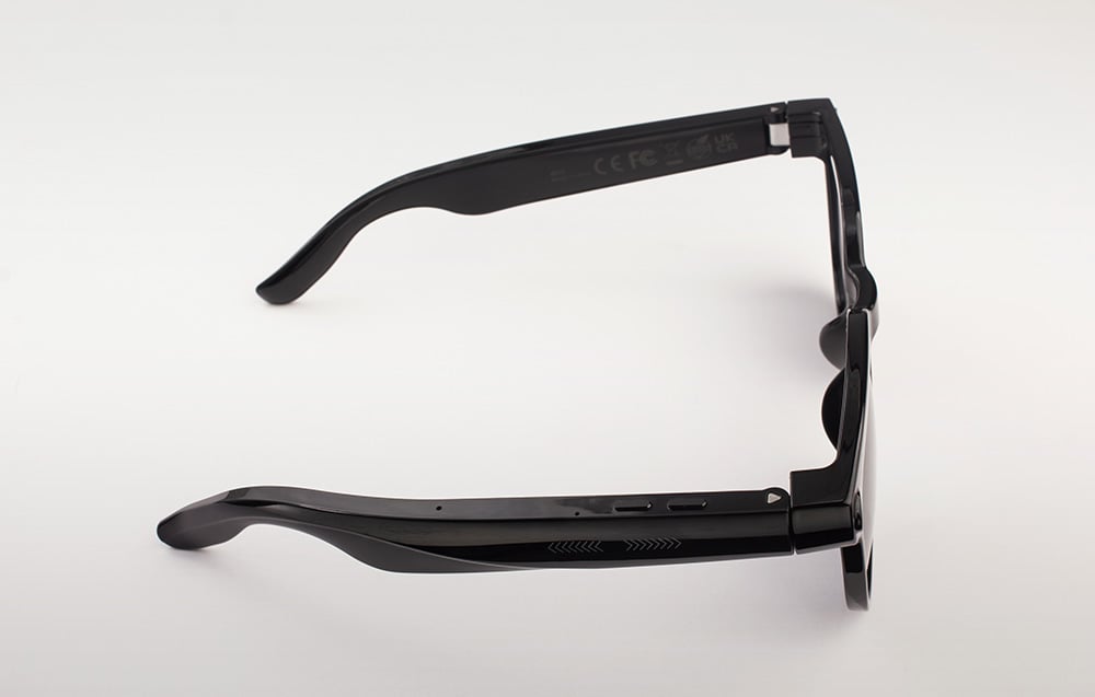 A man wearing glasses from which light projects onto a virtual screen showing a skier in the mountains.