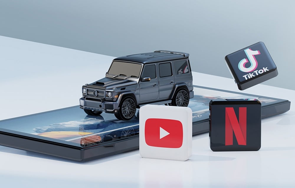 Black off-road car model on the screen next to YouTube, Netflix, and TikTok app icons