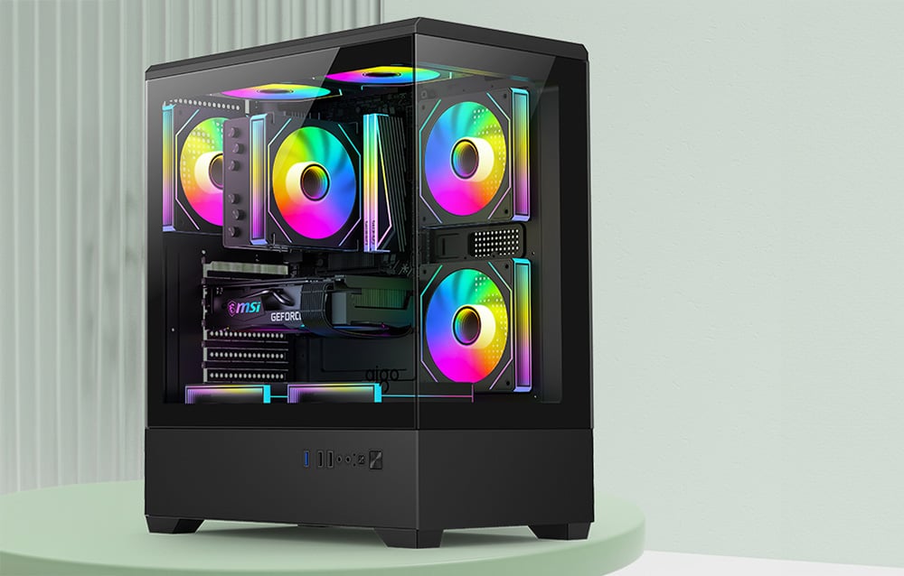 Black computer case with RGB fans in a green setting