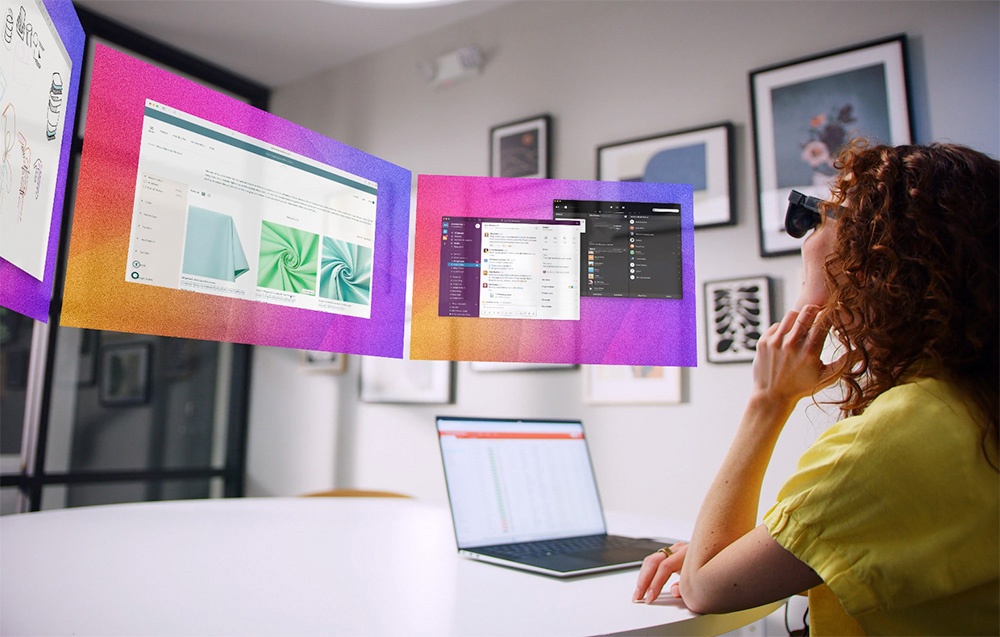A woman wearing augmented reality glasses looks at virtual screens with apps and websites floating in the air