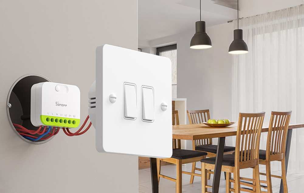 Sonoff switch with connected wires and a classic switch in a modern dining room
