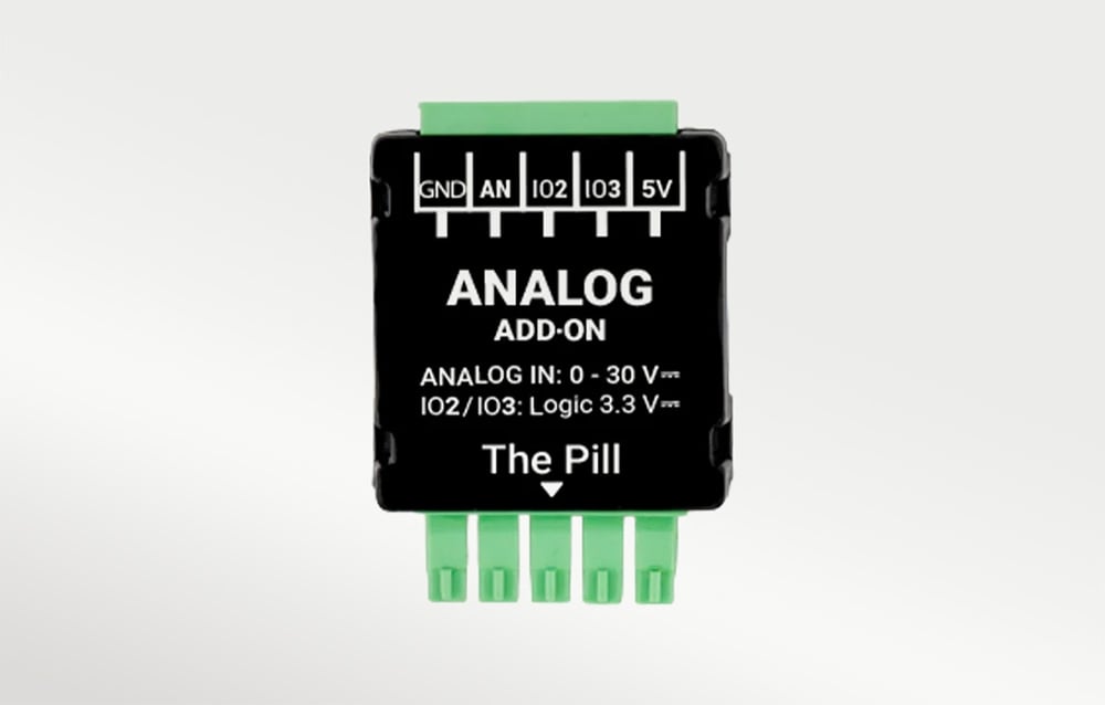 Black housing with green connectors and white “ANALOG ADD-ON” and “The Pill” lettering on a light background