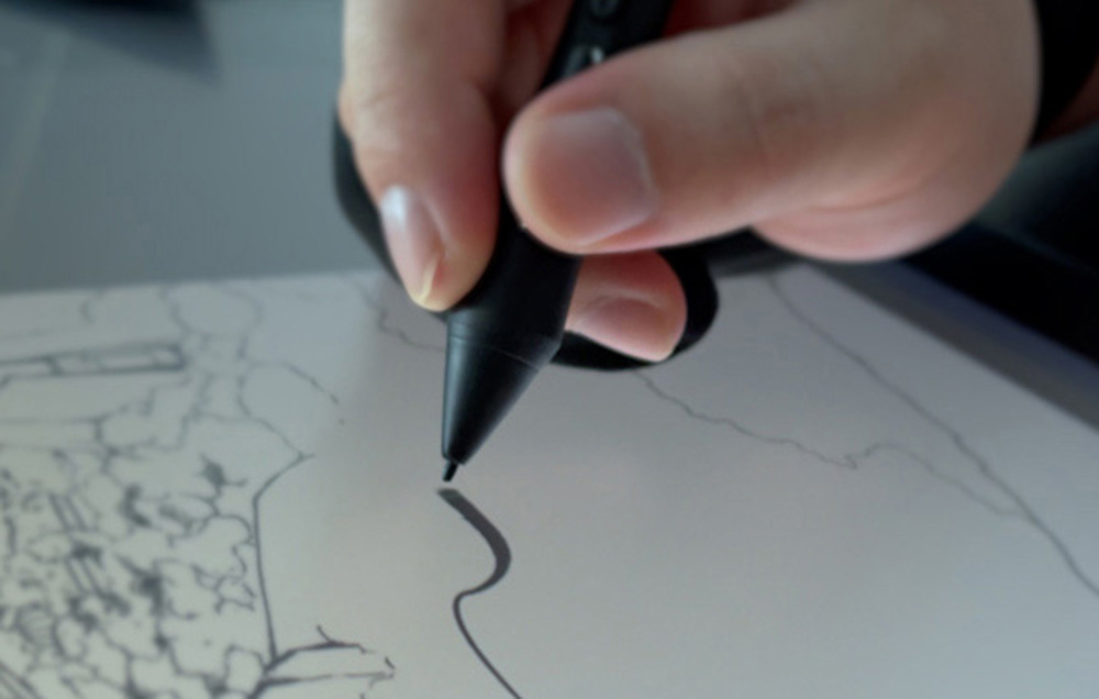 Person drawing sketch on Huion graphics tablet, top view of hand with stylus while working