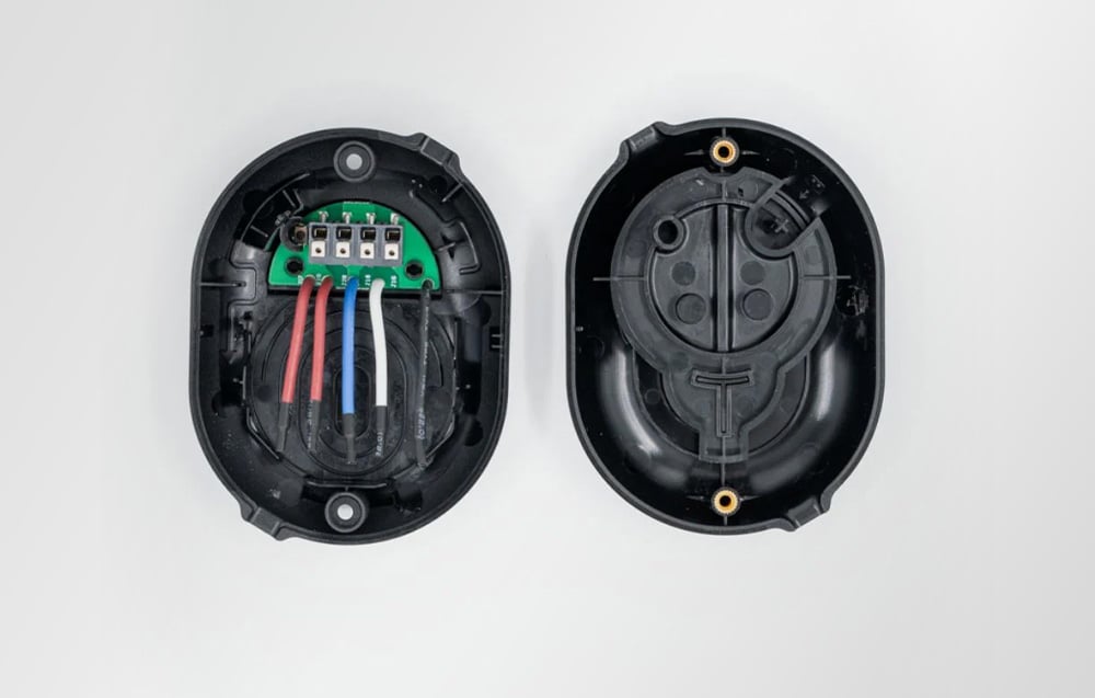 Interior of black Shelly Button Add-on accessory with connectors and wires visible.