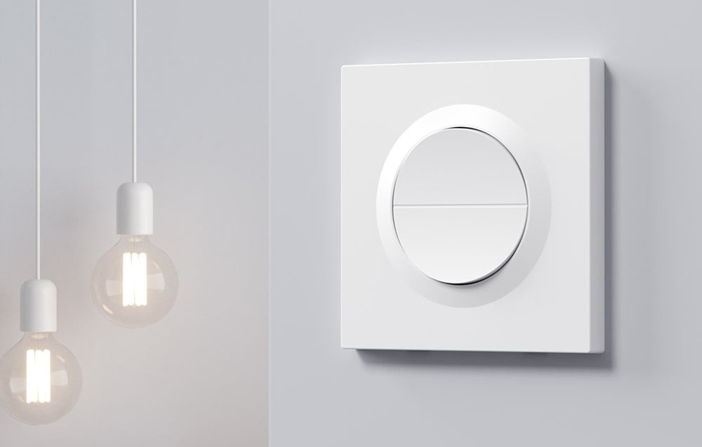 SONOFF's white round touch switch with two buttons against a backdrop of minimalist pendant lamps