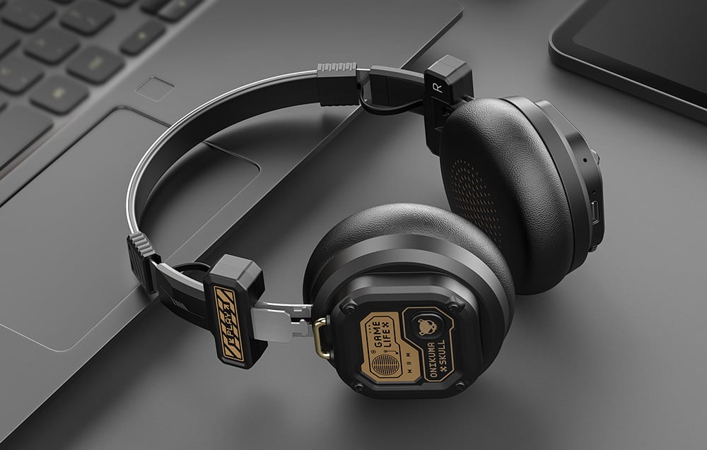Gaming headphones lying on a laptop, with a smartphone next to them