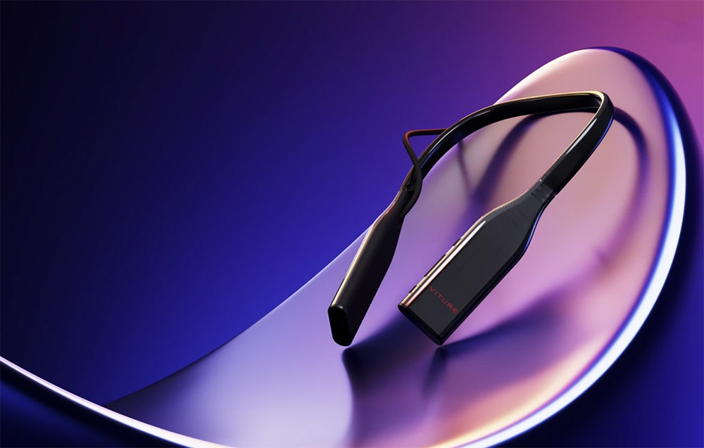 Black neckband device by VITURE presented on a glossy curved surface in purple-blue light