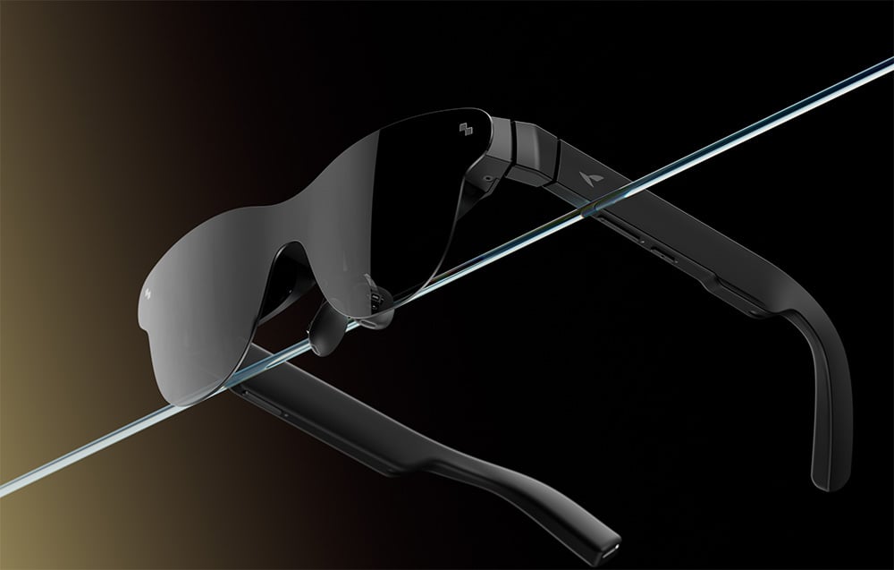 Black sunglasses with a single lens, cut diagonally by a transparent strip of glass