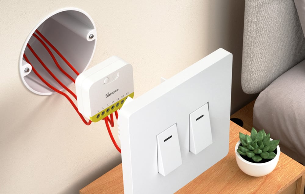 Sonoff mini switch installed in a junction box behind a light switch