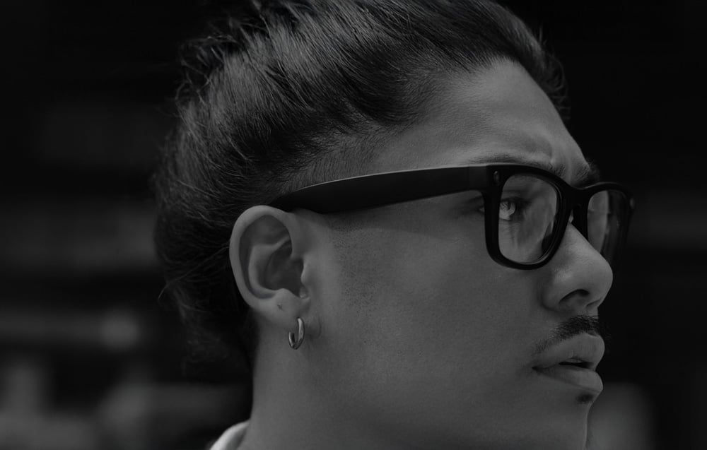 A man with an earring wearing AI glasses