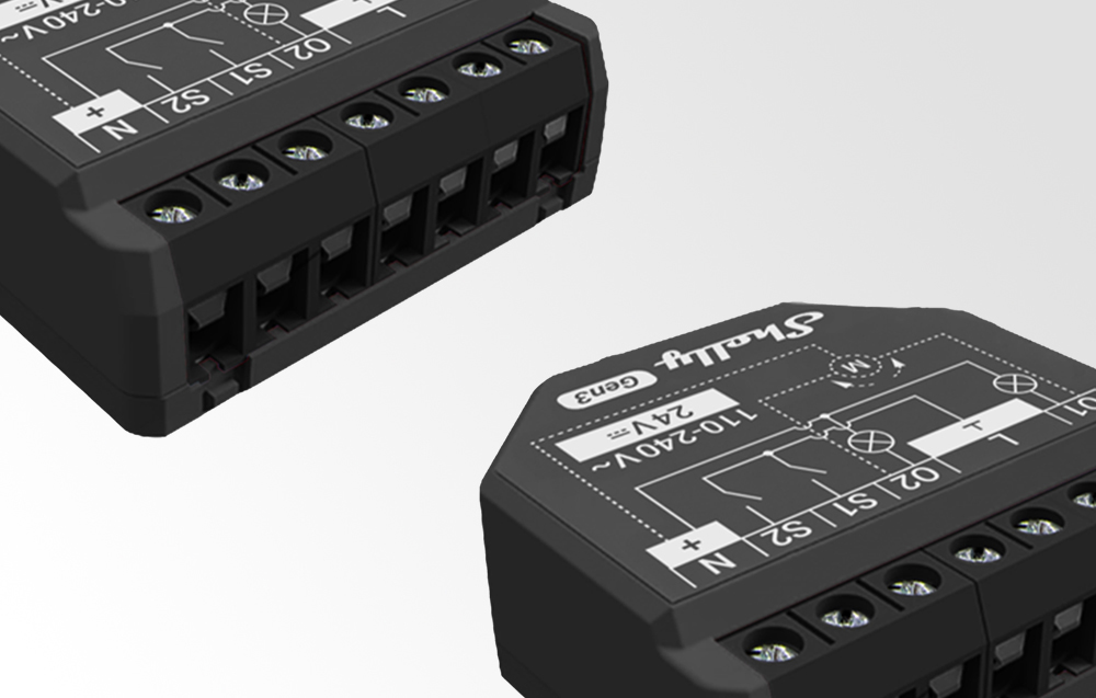 Close-up of two black Shelly 2PM Gen3 modules with visible markings and connection slots