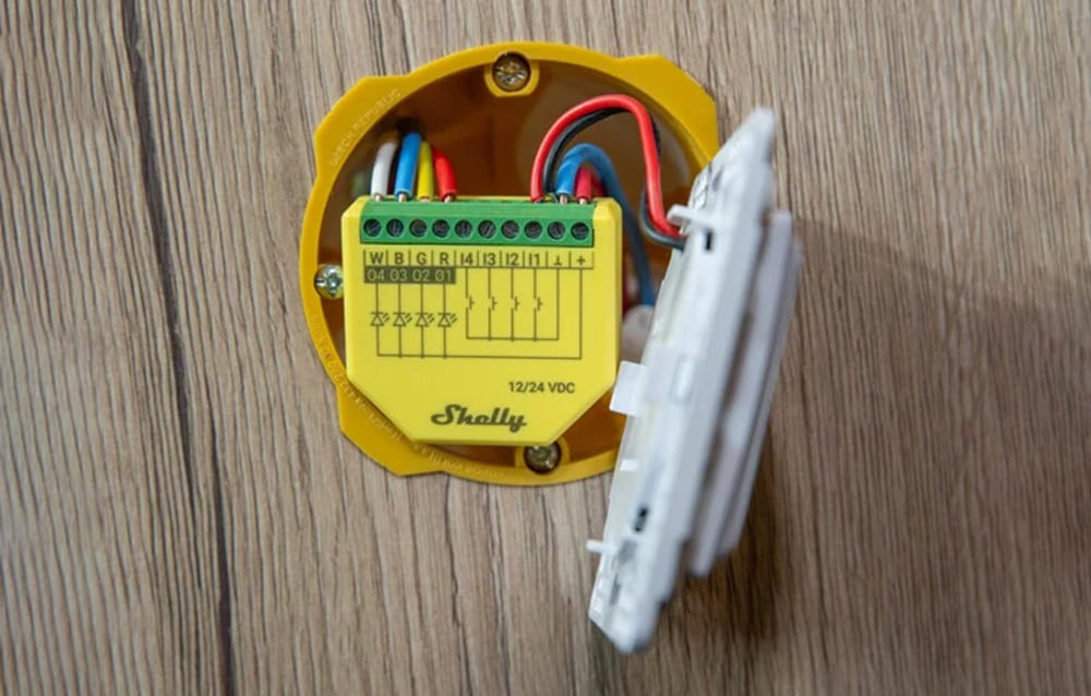 Yellow Shelly LED strip controller in an installation box