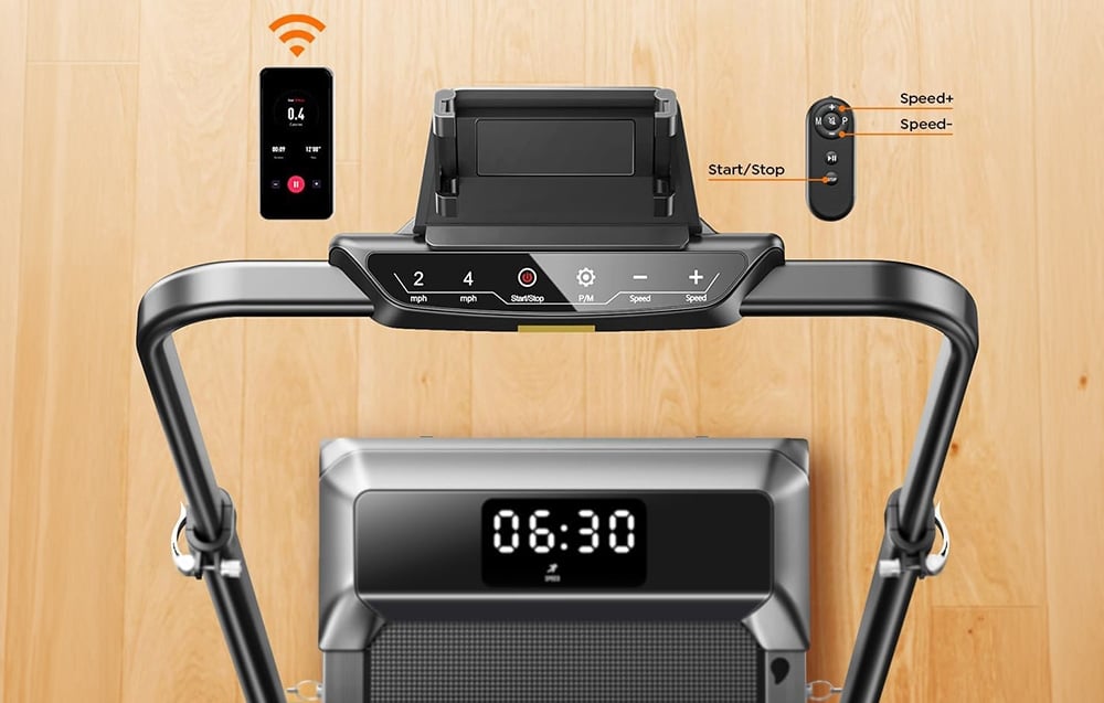 A treadmill with a display, with a smartphone and remote control visible above it