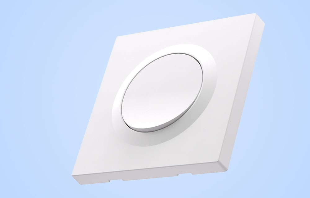 White wall switch housing on light blue background.