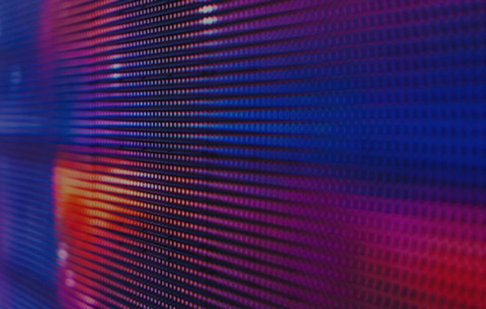 Macro detail of the tablet's display showing the pixel structure of the screen with a color gradient
