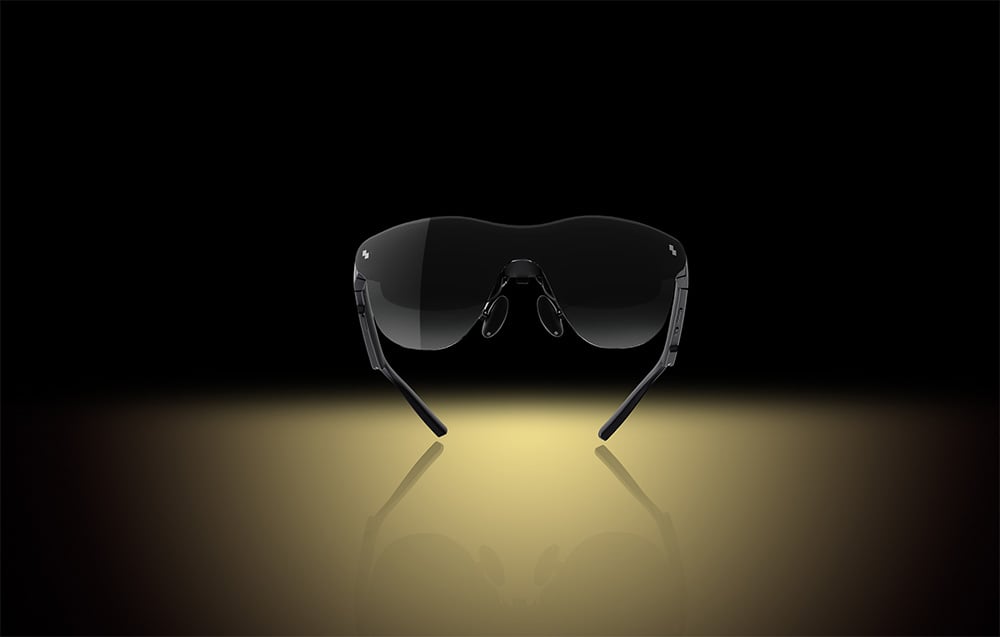 Front view of black sunglasses standing on a bright light background