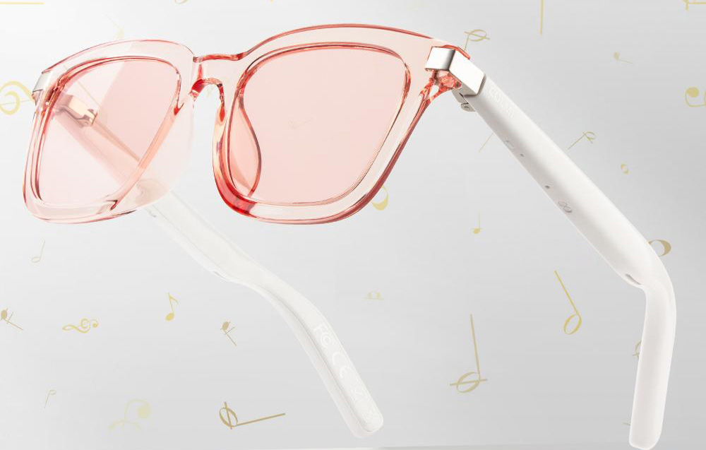 Pink glasses on a gray background with gold accents
