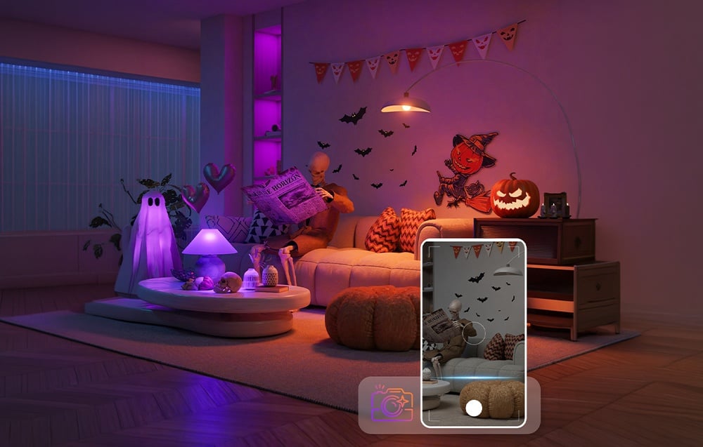 A Halloween decoration sitting on the couch with a newspaper in a living room decorated with pumpkins and purple lighting.