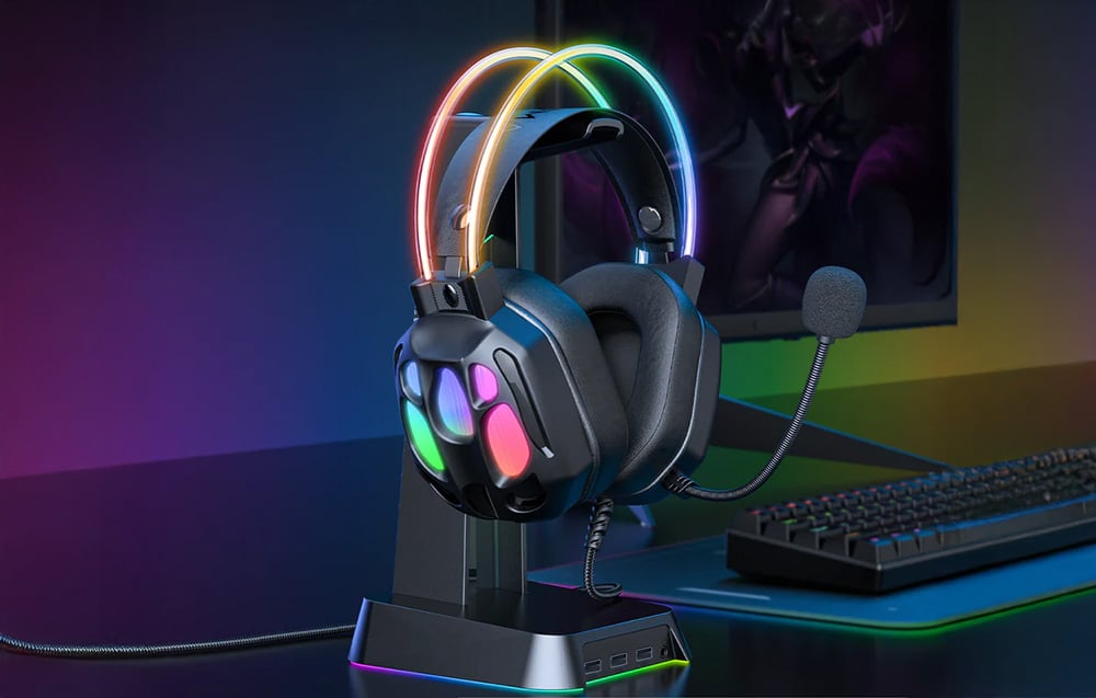 In-ear headphones on a stand next to keyboard and monitor