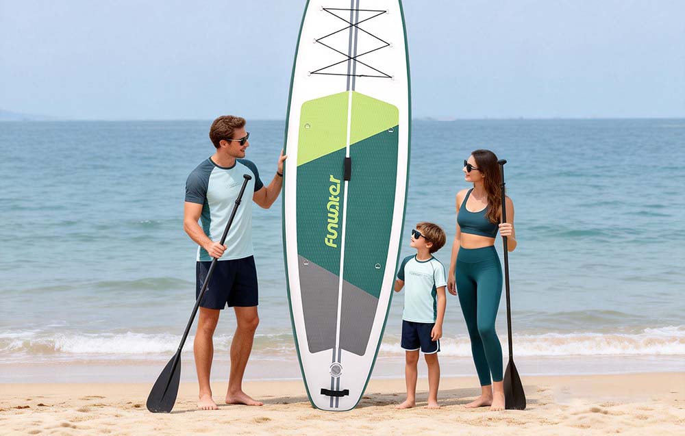 Family with a child on the beach, man holding a surfboard and paddle