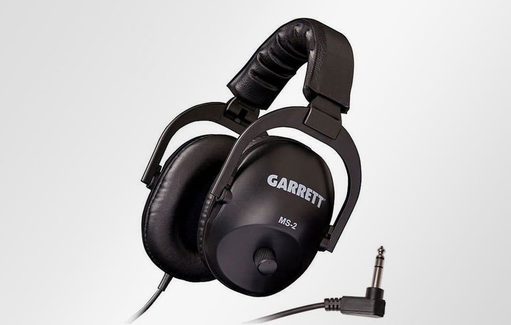 Metal detector headphones with audio jack cable on gray background