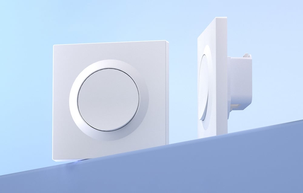 2 white switch housings lie on a blue table.