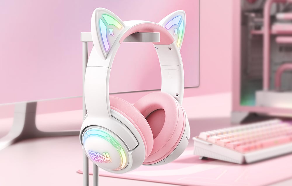 Gaming headphones hanging on a bracket, next to it is a monitor and keyboard