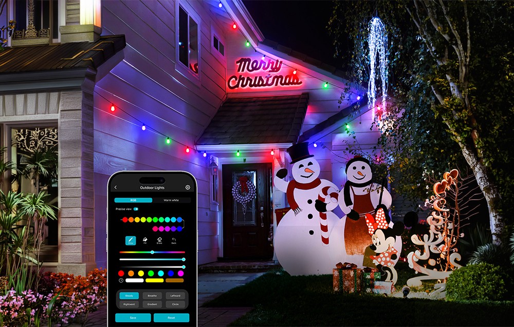 The front of a house decorated for the holidays with snowmen, an RGB string light, and a smartphone with a control app.