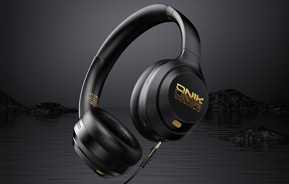 Black gaming headphones against a background of dark rocks and water