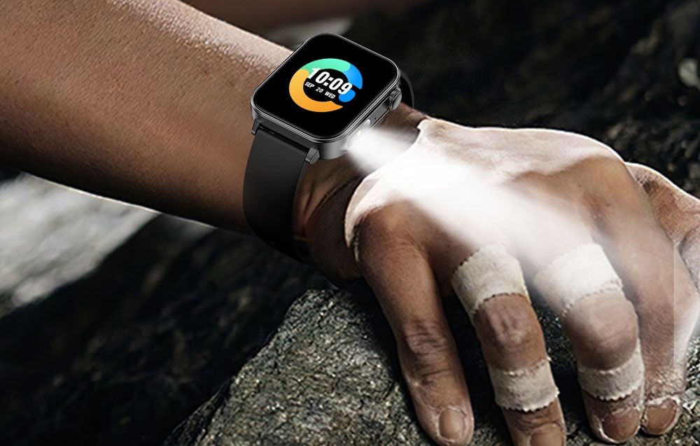 Smartwatch with flashlight on man's wrist.