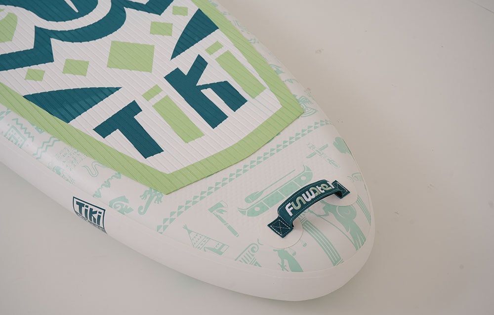 Close-up of a FunWater surfboard lying on a white floor