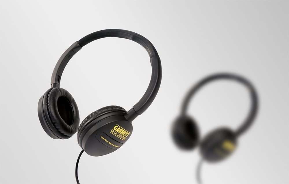 Two pairs of black headphones, one in the foreground and the other blurred in the background.