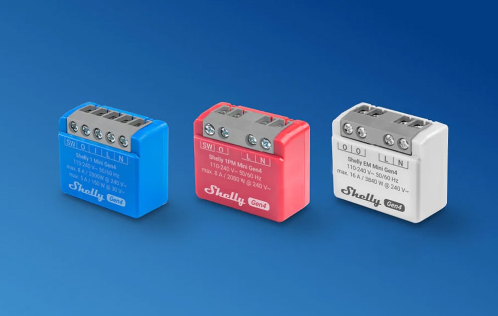 Three small controllers side by side in blue, red, and white on a blue background.