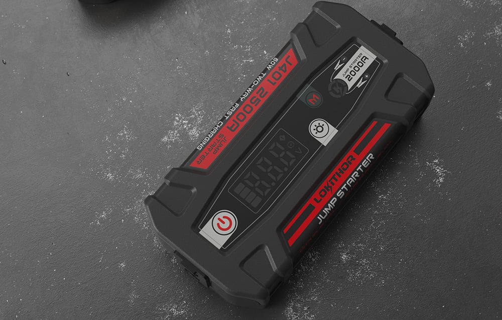 Top view of a black, portable jump starter with a digital screen and red graphic elements.