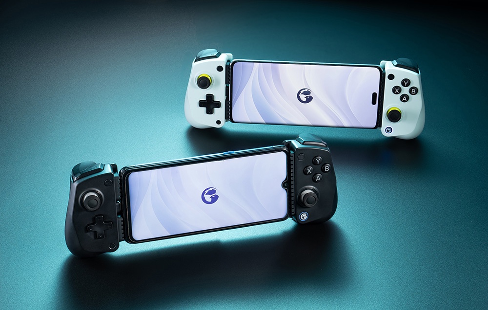 Two GameSir controllers with smartphones mounted, white and black models, positioned on a blue surface.